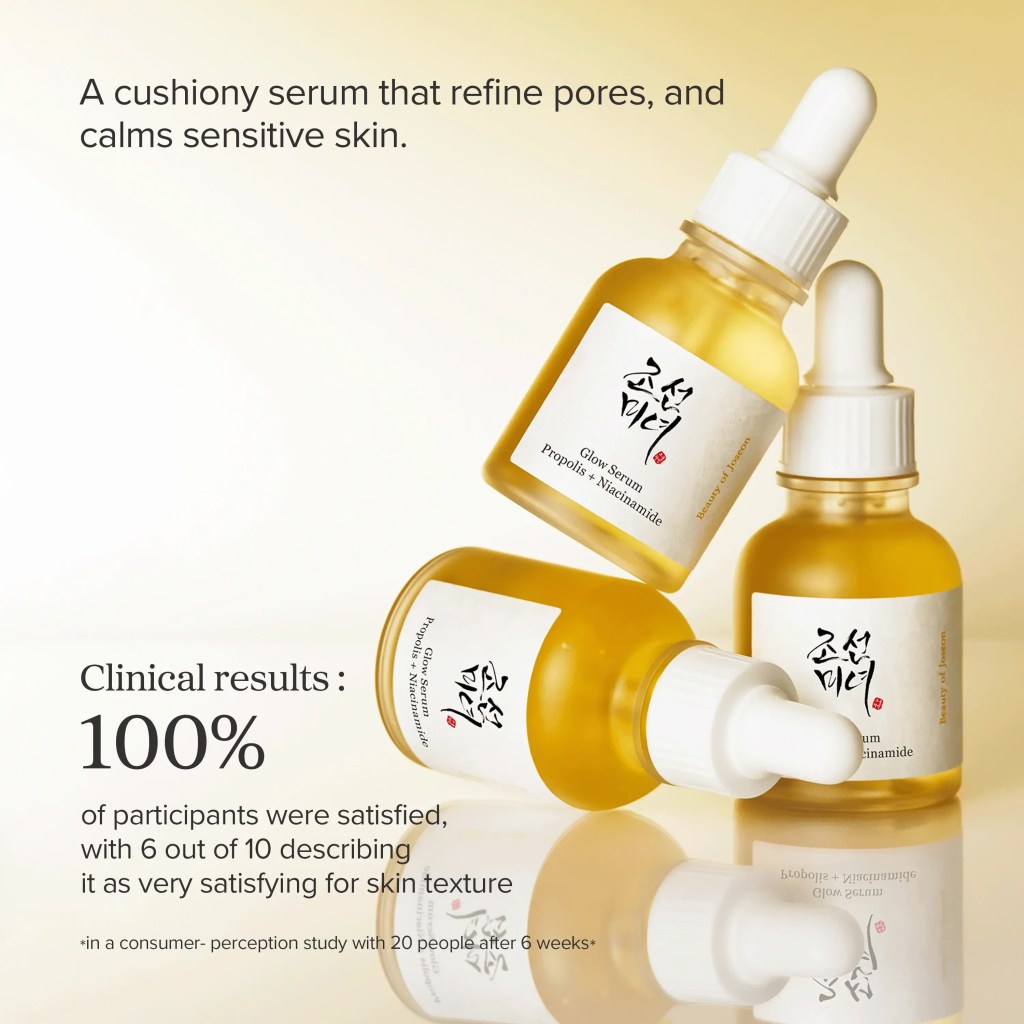 Three amber glass bottles of a cushiony serum labeled 'Glow Serum Propolis x Niacinamide' on a reflective surface. The image indicates that 100% of participants in a clinical study were satisfied with the product.